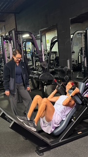 Debra Basch coaching a woman through a resistance training set at Hammer Fitness, Toronto
