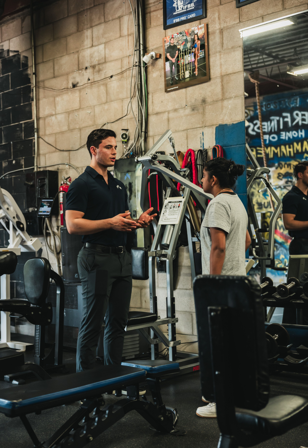 Keyvan Billou coaching a client on the training floor at Hammer Fitness in Scarborough, Toronto