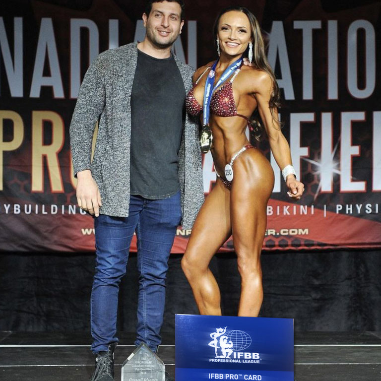 Hammer Fitness athlete on stage after earning an IFBB pro card under Amer Kamra